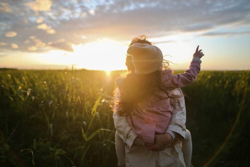 Mom and daughter in a cornfield.